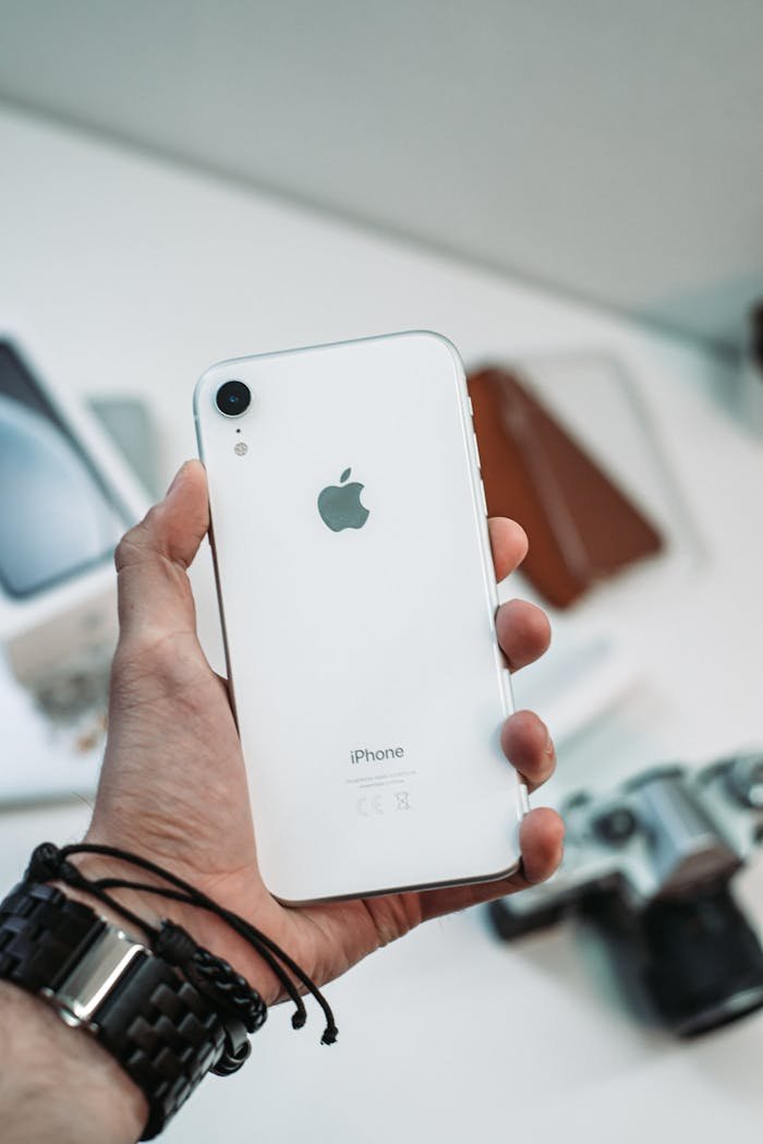 A close-up shot of a hand holding a smartphone with blurred background, Tuapse, Russia.